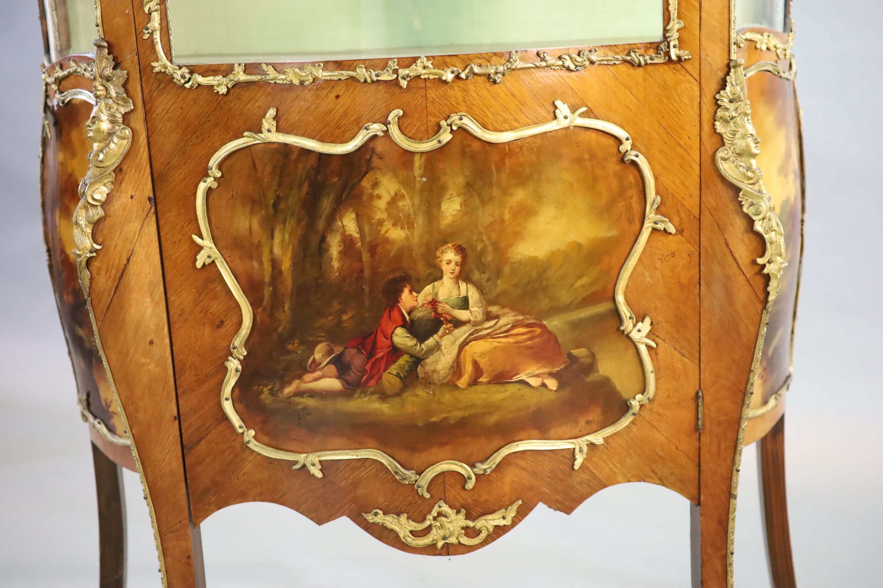 A Louis XV style mahogany vitrine, 76cm wide, 38cm deep, 194cm high.